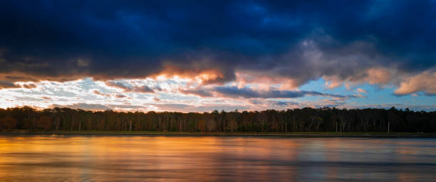 istock Dramatic sunrise cloudscape over the Cape Cod Canal Riverbank. Long exposure photography. 1351548399