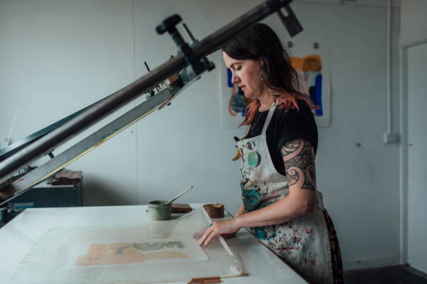 istock Artist and Printmaker working a printing press 1351548452
