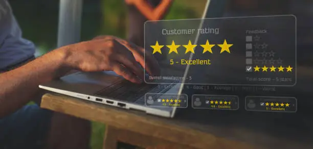 Photo of Businessman leaving feedback with his laptop with a virtual screen interface.