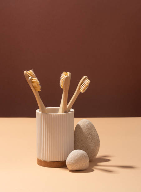 istock Wooden toothbrushes on brown background, zero waste 1351552036
