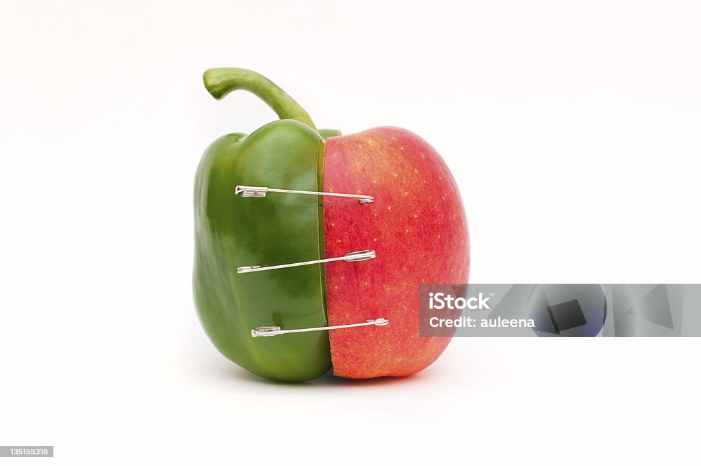 Merge of pepper and apple Concept of genetic modification, merge of apple and pepper Merging Stock Photo