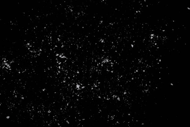 istock White crystals of sugar scattered on a black surface. 1351555012