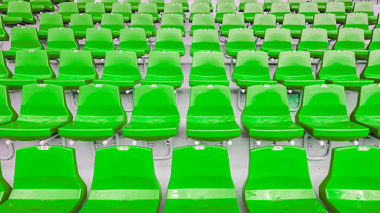 Perspective view of empty green plastic stadium seats