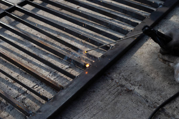 istock Iron gate repair, Worker hand welding steel 1351557449