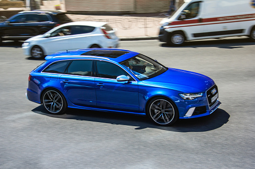 Kiev, Ukraine - June 19, 2021: Blurred car. CAR OUT OF FOCUS. Blue Audi RS6 Avant in motion