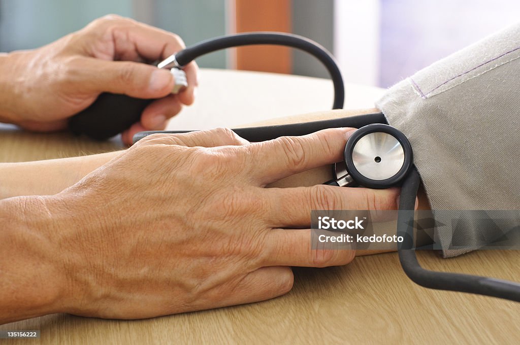 Doctor measuring blood pressure Focus on Stethoscope 21st Century Stock Photo