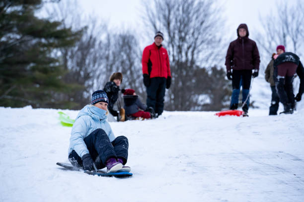 istock Family tobogganing during winter. 1351567429
