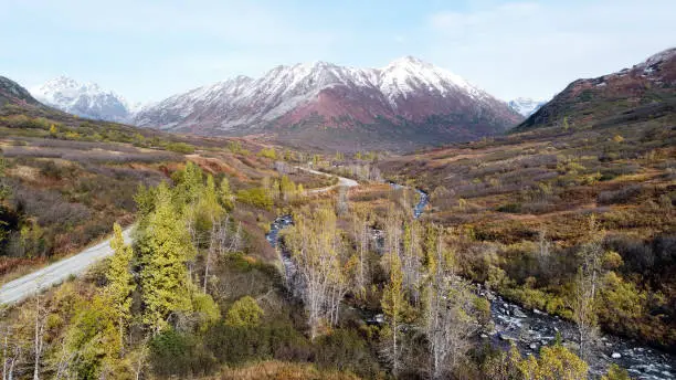 High view of Hatcher Pass Road with mountain and creek view in Palmer, Alaska.