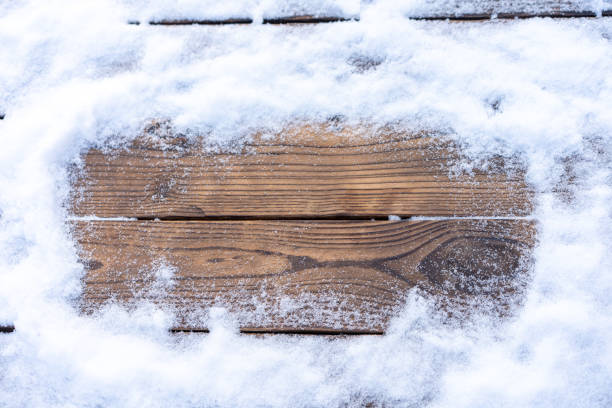 istock Winter background. Empty wooden plank with snow border, copy space for text 1351574257