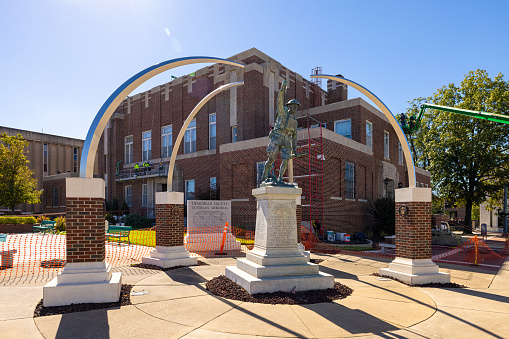 Jonesboro, Arkansas, USA - October 18, 2021: The Historic Craighead County Courthouse under restoration and the Veterans Memorial