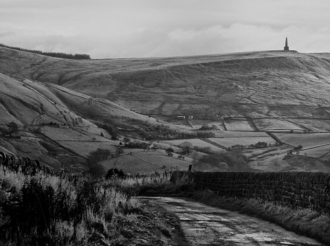 twilight in a dramatic west yorkshire winter landscape with a country lane surrounded by pennine hills