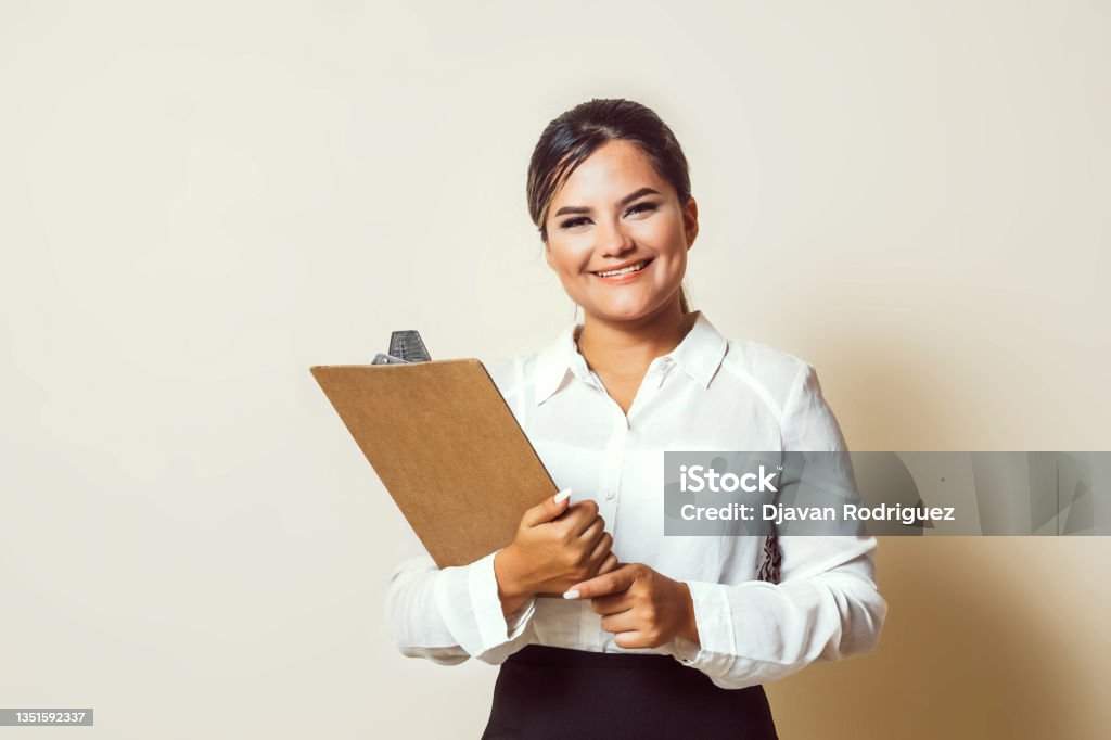 Assistant latinx woman holding a clipboard for job interview. recruiter concept. Recruiter Stock Photo