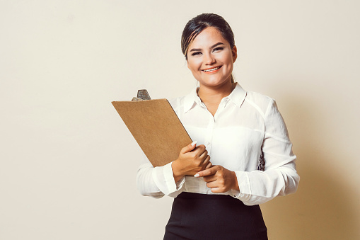 Secretary hispanic woman holding a clipboard job interview concept.