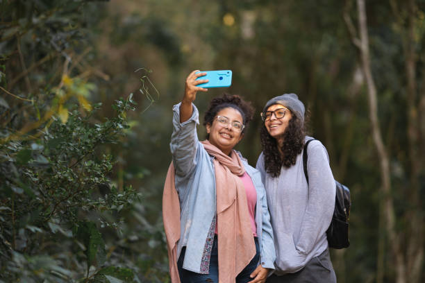 istock Friends taking selfies on a forest trail 1351599168