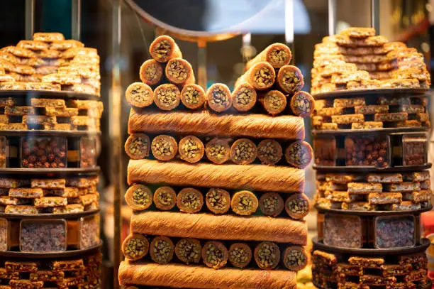 Photo of Tasty Oriental sweets baklava. traditional oriental sweets baklava with nuts. Eastern sweets in a wide range, baklava, Turkish delight with almond, cashew and pistachio nuts on plates