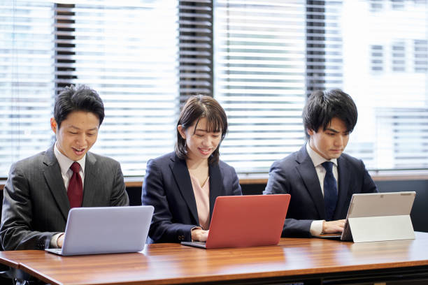 istock Asian business person working on a computer 1351600005