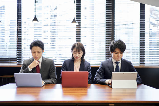 istock Asian business person working on a computer 1351600008