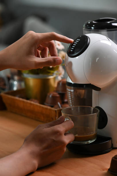 istock Close up view man making coffee with a coffee machine. 1351600124