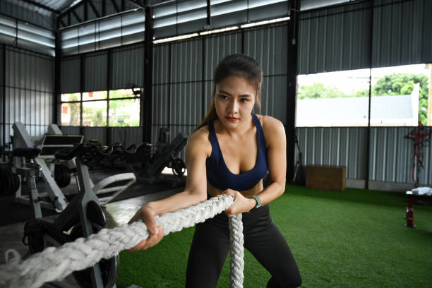 istock Attractive sportswoman doing exercise with battle ropes. 1351600320