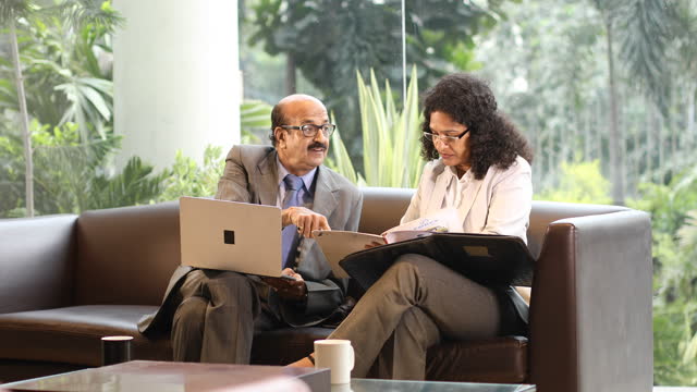 Business people using laptop and discussing at office