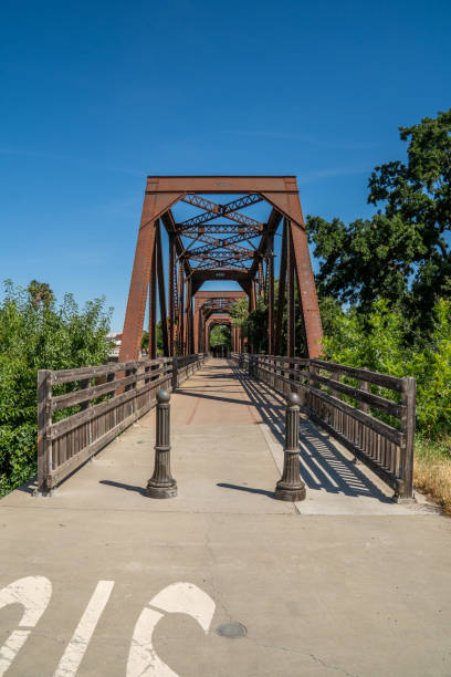 istock Old iron rusty bridge over a Putah Creek in Winters CA. 1351606511