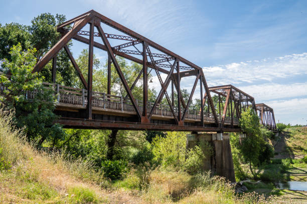 istock Old iron rusty bridge over a Putah Creek in Winters CA. 1351606518