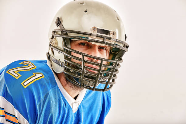 Dramatic 3D rendered football helmet with red stripe over black background with clipping mask.