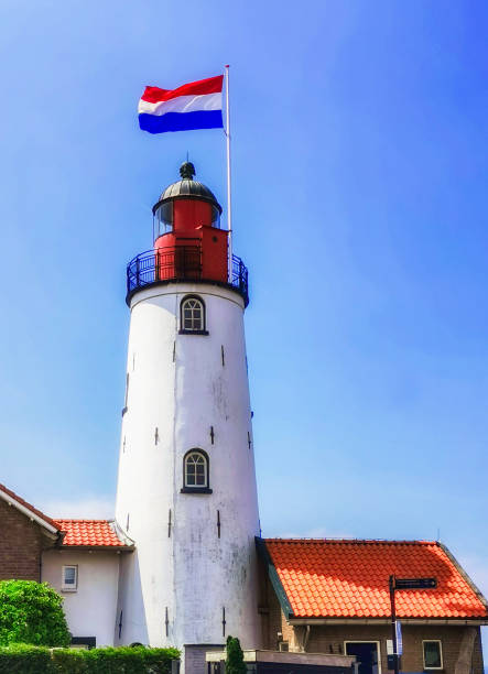 istock Lighthouse with Dutch flag Urk Netherlands 1351610955