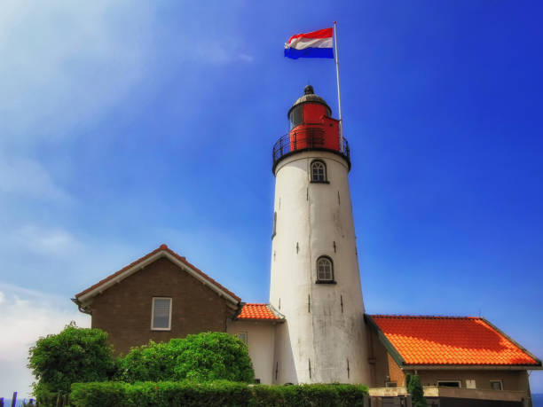 istock Lighthouse with Dutch flag Urk Netherlands 1351610965