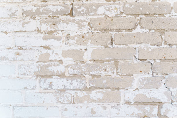 istock Brick wall texture with faded white paint. 1351616485