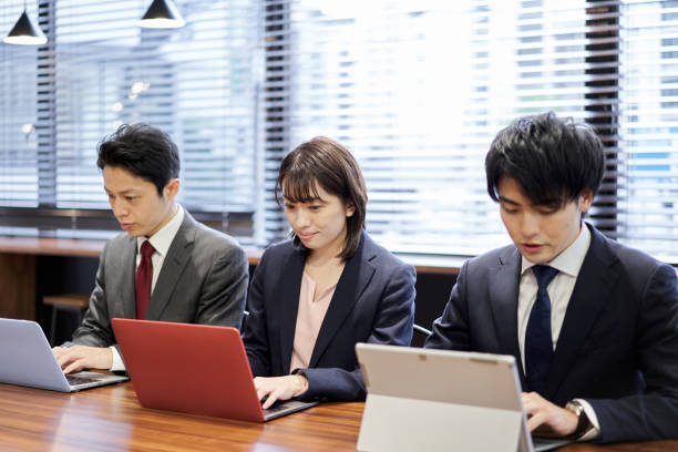 istock Asian business person working on a computer 1351621006