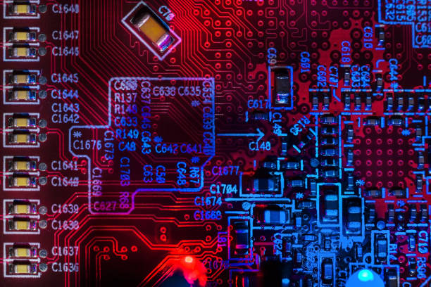 istock Macro close-up shot of a microchip, processor (CPU) on a blue high-tech electronic printed circuit board (PCB), a computer motherboard with components inside an electronic device, a part of a video card 1351621093