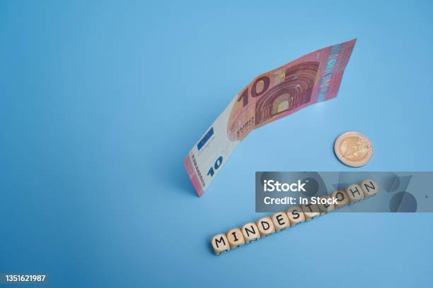 Letters On Wood Dice Saying Minimum Wage Contribution To The Theme Of Political Parties For Fair Pay For Workers In Germany 12 Euro Minimum Wage Stock Photo - Download Image Now