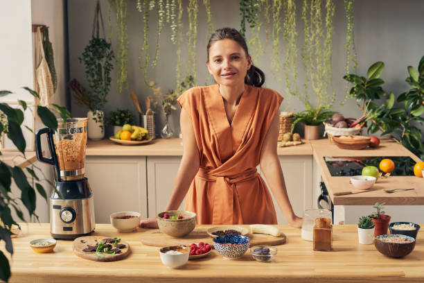 istock Happy young housewife looking at you while cooking 1351622004