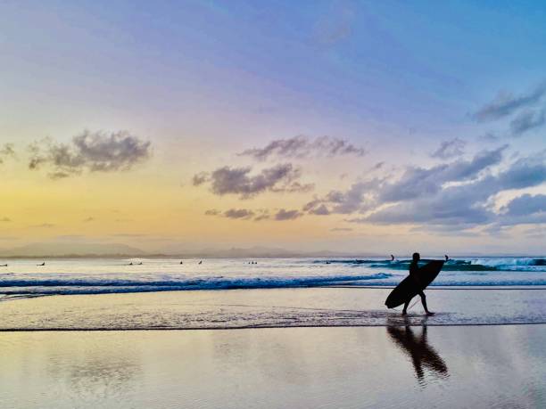 istock Silhouette of Ocean Surfer at Sunset 1351623037