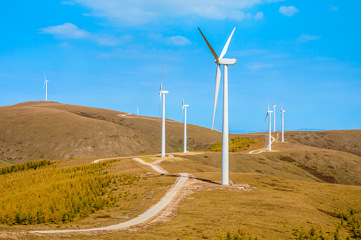 Wind turbine landscape on the top of the mountain. Mountains and wind turbines scenery in the autumn season.