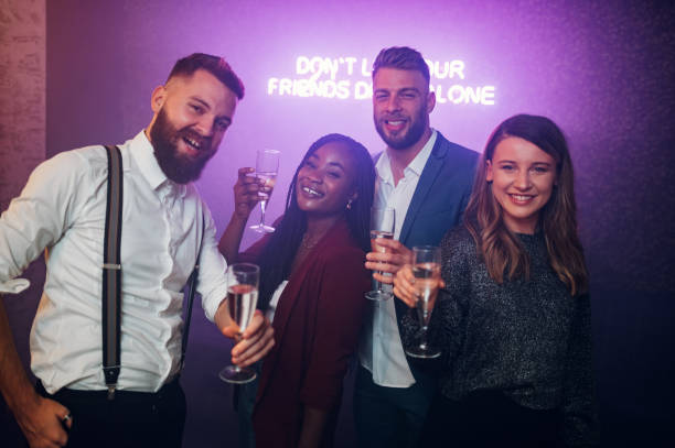 istock Friends dancing on a party in a club while drinking champagne 1351623240