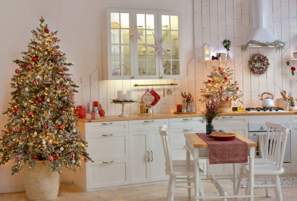 istock Interior of a light white ?hristmas kitchen with red decor elements in the Scandinavian style. Christmas decorations. Breakfast 1351625141