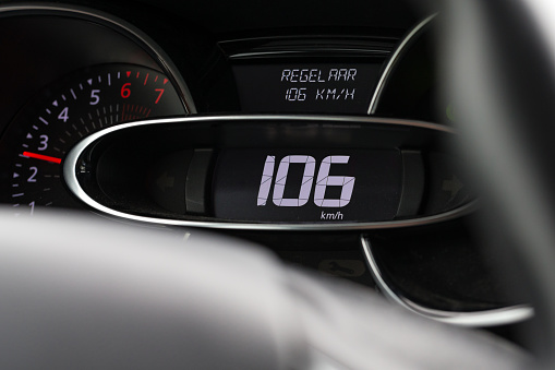 Enschede, Twente, Overijssel, Netherlands, october 13th 2021, close-up of the digital speedometer of a 4th generation Renault Clio using cruisecontrol, driving at a velocity of 106 km/h - captured from the passenger seat - the Clio is made by French, Boulogne-Billancourt based manufacturer Renault since 1990