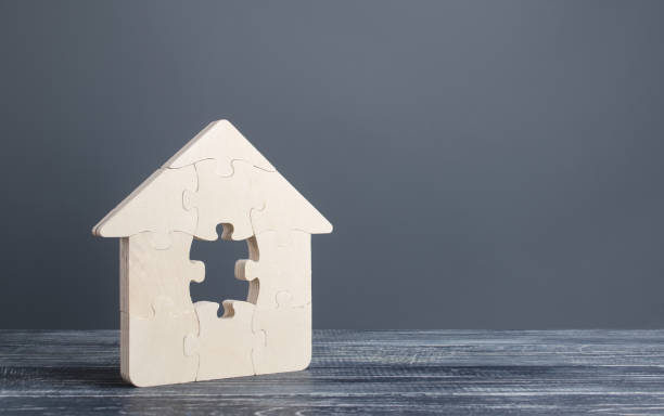 istock Puzzle house with a missing piece. Purchase or construction comfortable dream home. Mortgage loan purchase real estate. Arrangement premises repair. Availability and cheapness. Finish building 1351631774