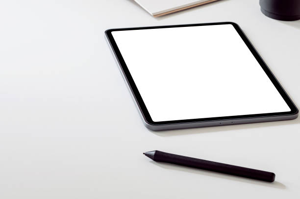 istock Mockup portable tablet with stylus pen on white top table. 1351631826