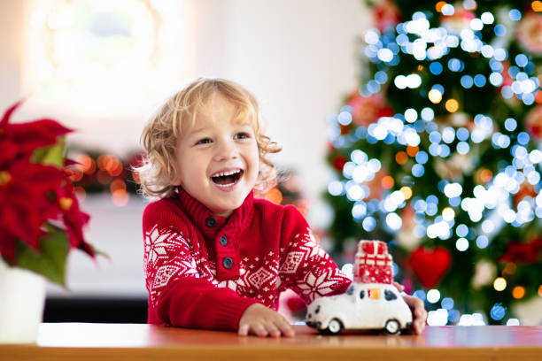 istock Child with Christmas present. Kid with Xmas gift. 1351631832