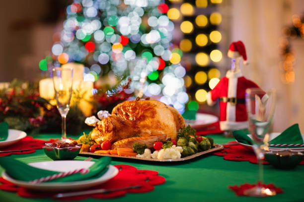 Christmas dinner at fire place and Xmas tree. stock photo