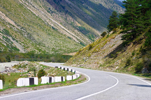 istock Mountain highway through the forest landscape. North Caucasus travel 1351634075