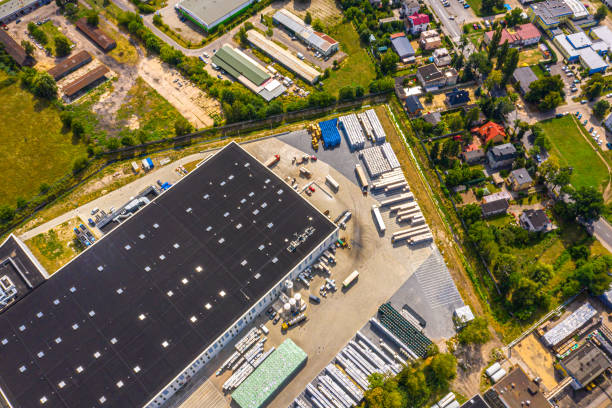 Aerial view of goods warehouse. Logistics delivery center in industrial city zone from above. Aerial view of trucks loading at logistic center. View from drone. Aerial view of goods warehouse. Logistics delivery center in industrial city zone from above. Aerial view of trucks loading at logistic center. View from drone. commercial real estate stock pictures, royalty-free photos & images