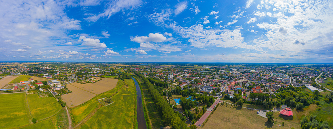 Top aerial panoramic view of Lowicz old town historical city centre with Rynek Market Square, Old Town Hall, New City Hall, colorful buildings with multicolored facade and tiled roofs, Poland