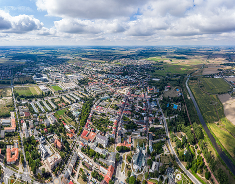 Top aerial panoramic view of Lowicz old town historical city centre with Rynek Market Square, Old Town Hall, New City Hall, colorful buildings with multicolored facade and tiled roofs, Poland