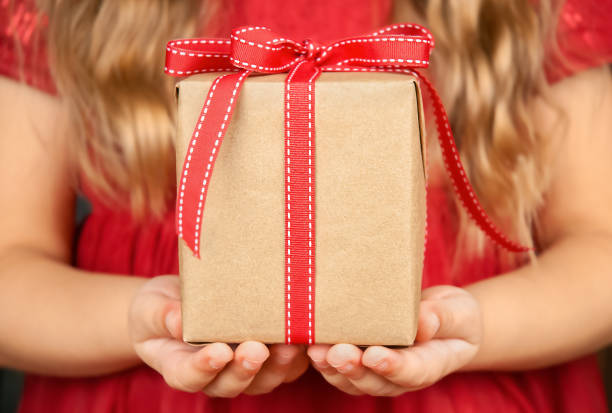 istock Gift box in girl's hands 1351637313