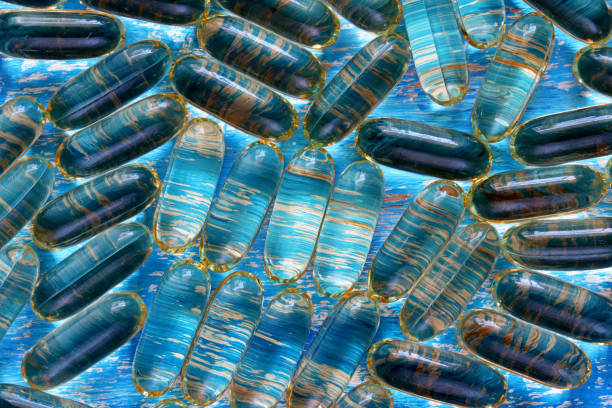 istock transparent pills on blue background 1351638339
