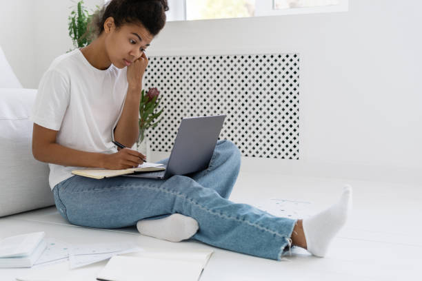istock Young african american student watching boring online lecture 1351642384